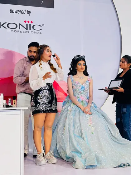 On stage at Pro Beauty India, demonstrating a fantasy look. I am explaining the techniques while my assistants help.