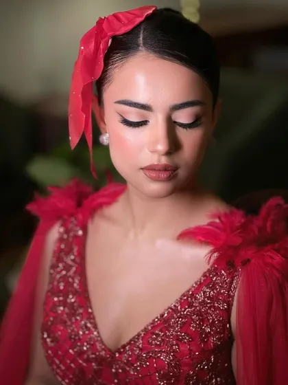 A close-up on the vintage glamour. The sharp winged liner, high bun, and flawless skin create a look that is pure Hollywood.