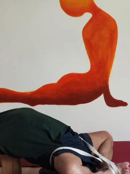 A restorative backbend using a bench, with the legs in Baddha Konasana (Bound Angle Pose). This opens both the chest and the inner thighs.