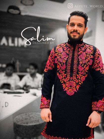 Another look at the black kurta with red and pink floral embroidery. The detail and color combination are perfect for festive celebrations.