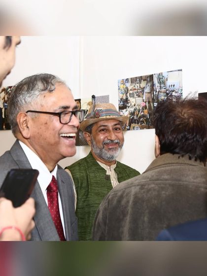 A candid photo from my exhibition at the India International Centre, sharing a laugh with visitors. These interactions are the most rewarding part of showcasing my art.