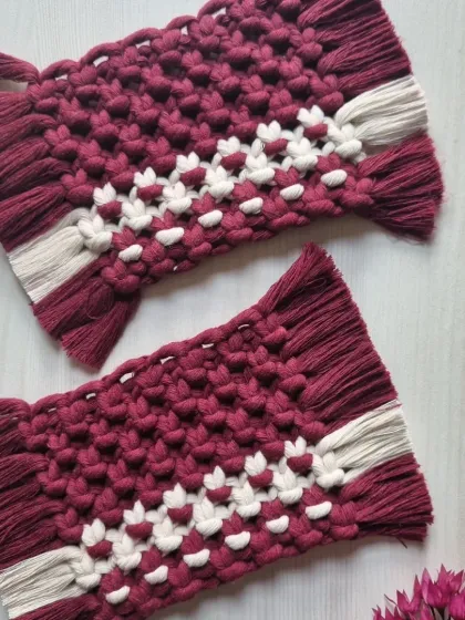A beautiful pair of maroon and white rectangular coasters. The pattern adds a lovely detail to the rich color.