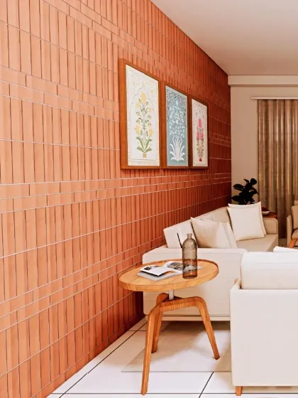 Another view of the terracotta accent wall, adorned with simple, elegant botanical prints. This shows how a single feature wall can add immense character to a room.