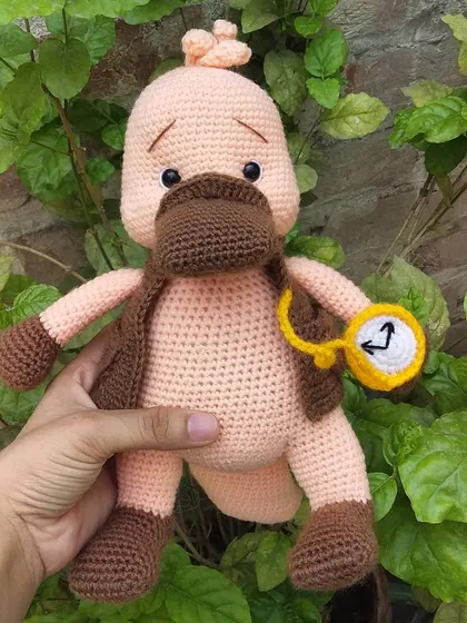 I made this quirky platypus character, complete with a little vest and a pocket watch. He looks like he's in a hurry for a very important date.