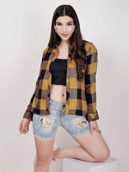 A kneeling pose adds variety to this e-commerce shoot for a plaid shirt, showing how the garment moves and fits in different positions.