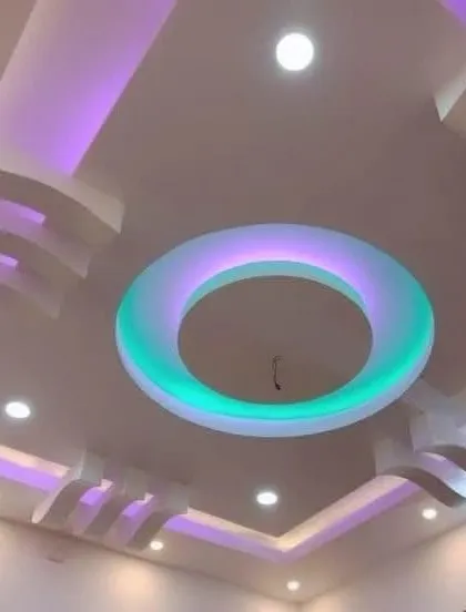 A floating ring with color-changing light is the centerpiece of this design. The surrounding levels have a soft purple glow, creating a layered lighting scheme.