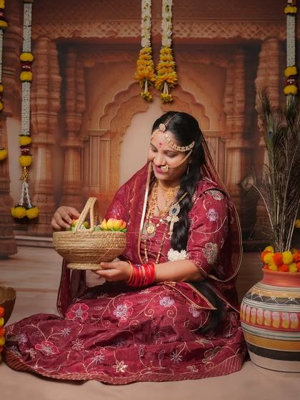 As part of our Krishna-themed baby shoot, we also capture beautiful portraits of the mother. Here, she is seen amidst the traditional setup, reflecting the devotion and joy of the occasion.