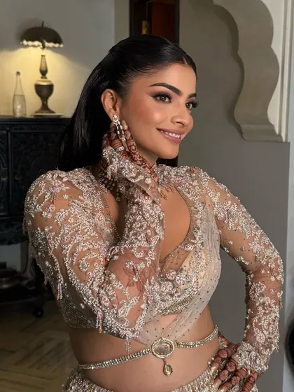 The bride's radiant smile, her hair perfectly styled for a glamorous night.