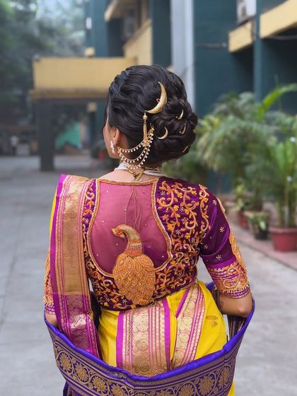 The full look of the Maharashtrian bridal hairstyle, showing how the bun and accessories complement the beautiful embroidered blouse and saree. It's a complete, regal look for the big day.