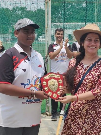 Presenting a well-deserved award. Our friendly competitions give every student, young or old, a chance to shine and be recognized.