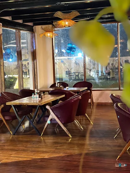 A view from inside the cafe, looking out onto the lawn. You can enjoy our delicious food while taking in the serene, green surroundings.