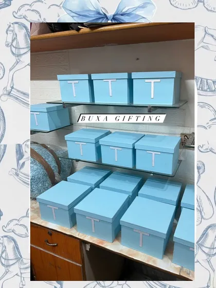 A display of the finished Baby Dior themed boxes, ready to add a touch of Parisian chic to a special baby announcement.