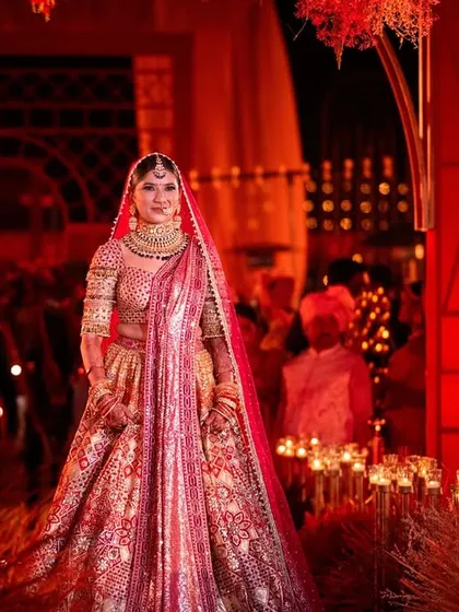 The bride's entrance is a moment of pure magic. For this wedding, we created a dramatic path lined with candles and set against a backdrop of rich red decor, ensuring her walk to the mandap was as breathtaking and emotional as the love story it celebrated.