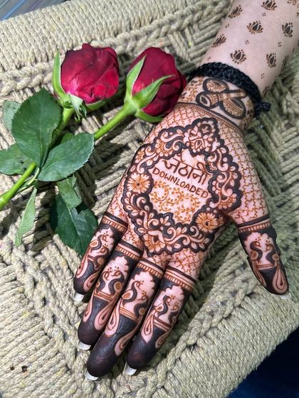 A fun take on maternity henna with "Jethani Downloaded" written in Hindi. A playful design to welcome a new member to the family.