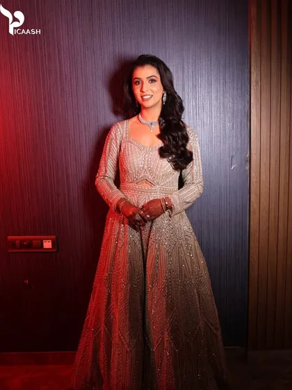 A full-length portrait of the bride in her stunning, embellished reception gown.