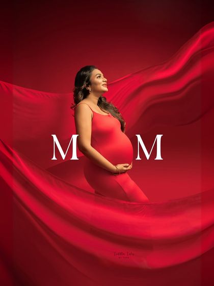 Wrapped in a sea of red. This shot, with its dramatic fabric and text overlay, is a powerful and artistic celebration of the journey to becoming a mother.