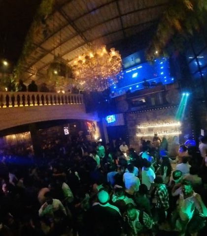 A fisheye lens captures the grand scale and packed floor of the club.
