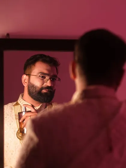 The groom's reflection, a moment before 'I do.' This portrait captures the quiet confidence and anticipation of a man about to begin his new chapter.