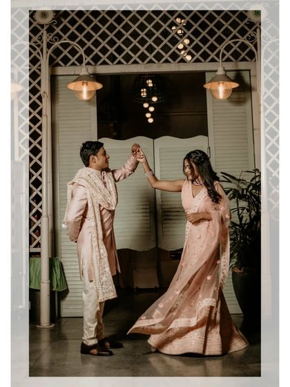 A playful moment as the couple shares a dance, their movement and joy captured perfectly.