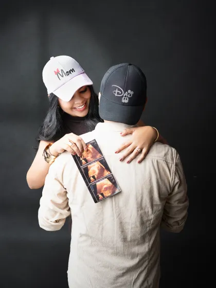 The first family photo. We love incorporating personal items like ultrasound scans into our sessions. This playful shot captures the couple's excitement and joy as they look at the first images of their baby, a beautiful start to their family album.