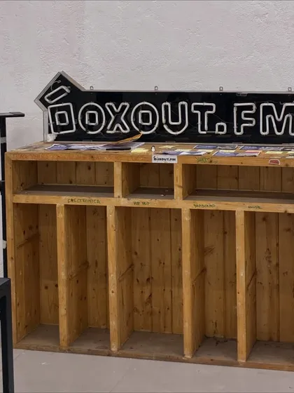 The original, custom-made Boxout.fm DJ booth, on display as a piece of our history. This booth has been the centerpiece of our studio and countless events since 2017.