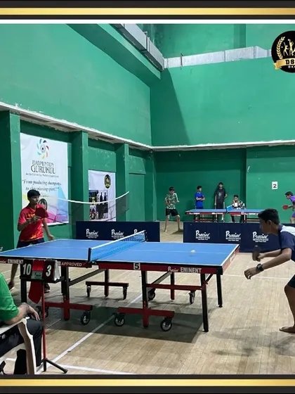 A fast-paced table tennis rally in action. Our indoor hall is equipped with professional tables and ample space for competitive matches and training.