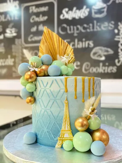 A studio shot of the elegant Paris-themed engagement cake.
