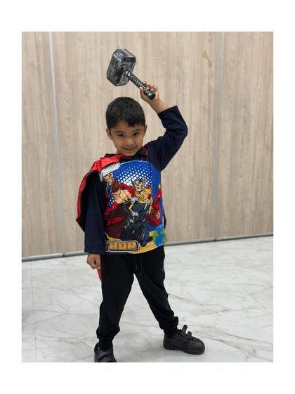 Wielding Thor's hammer, this little hero is ready to command the stage.