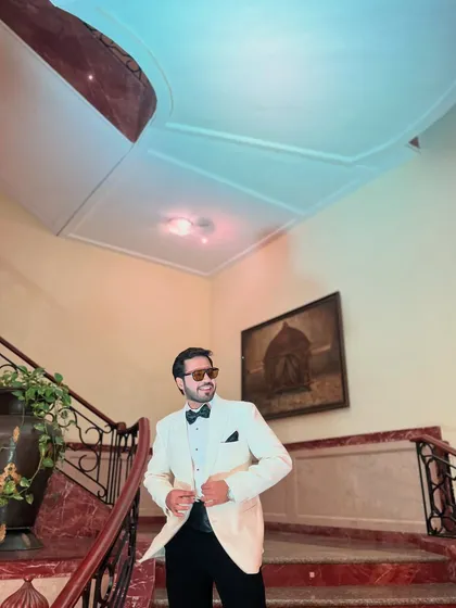 Adjusting my tuxedo, ready for the show. It's all in the details, from the outfit to the energy.