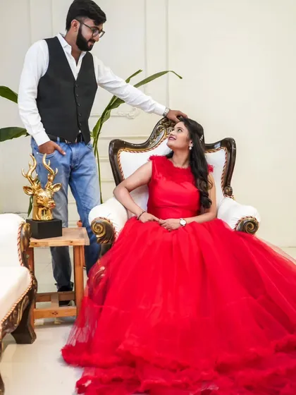 A regal pose for a special occasion. This stunning red ball gown with a ruffled trail makes for a truly royal pre-wedding portrait.