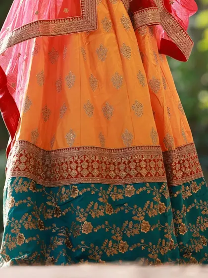 A detail shot focusing on the beautiful fabric and embroidery of the lehenga. This type of image is great for showcasing the work of the designers we collaborate with.