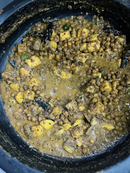 Kootu Curry is a cornerstone of any Sadya. My version for Vishu features yam and black chickpeas (Kadala) slow-cooked in a warm, toasted coconut masala, creating a thick, hearty, and nutritious curry.