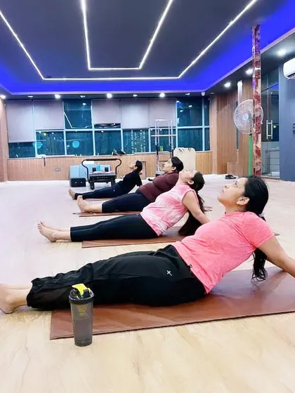 A glimpse into one of my group sessions. We are practicing Matsyasana (Fish Pose), a powerful heart opener. I keep my classes small to foster a supportive community and ensure every student gets the attention they need.