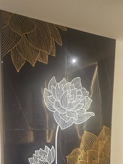 A modern floral design with gold and white inlay on black marble. This high-contrast piece is ideal for creating a sleek, luxurious accent wall.