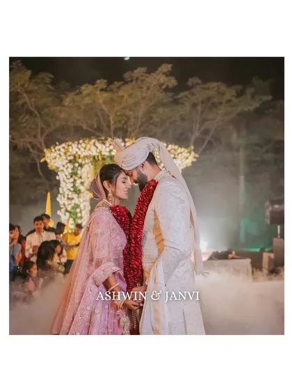 An intimate moment right after the varmala ceremony, with soft smoke creating a dreamy atmosphere. We focus on capturing the immediate connection and quiet joy between the couple as they begin their new life together.