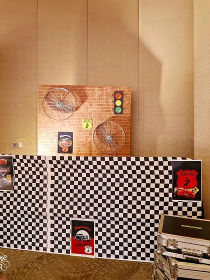 A DJ booth with a checkered-flag front, continuing the racing theme throughout every element of the party.
