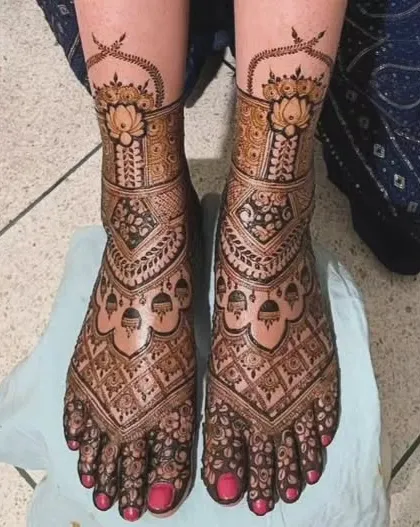A stunningly detailed foot design with lotus motifs and jhumkas, perfect for a bride.