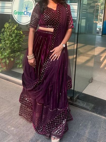 This rich purple velvet lehenga with sequin work is a luxurious choice for a winter wedding or reception. It's available for rent.