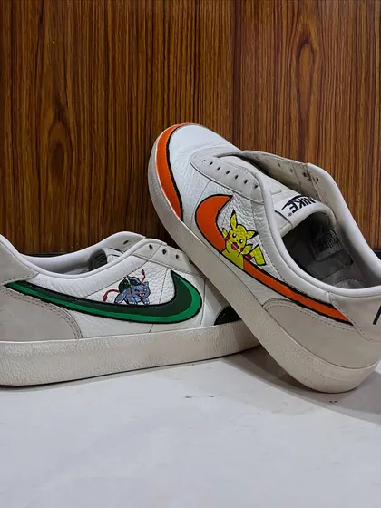 Another perspective of the finished Pokémon sneakers, showing how the art wraps around the shoe. This custom shoe painting project is a great example of how to personalize your favorite footwear.