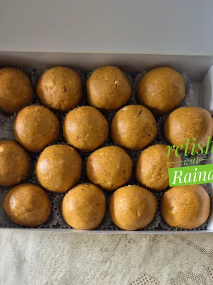 A close-up of Besan Laddoos in a box. The fine texture comes from roasting the flour perfectly on a slow flame, a process I never rush.