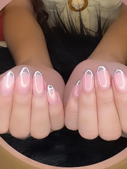A full view of the lavender chrome outlined French manicure, a unique and eye-catching style.