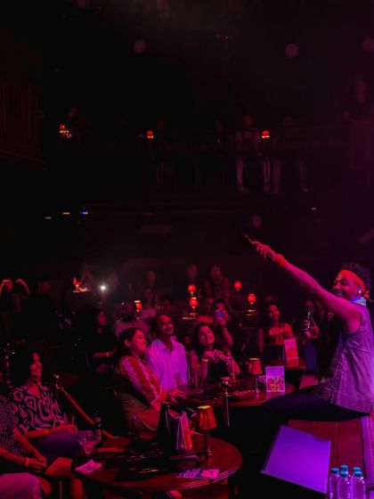 David Walters sits on the edge of the stage, connecting directly with the front row. This intimate moment shows how our hosted artists create a special bond with the audience.