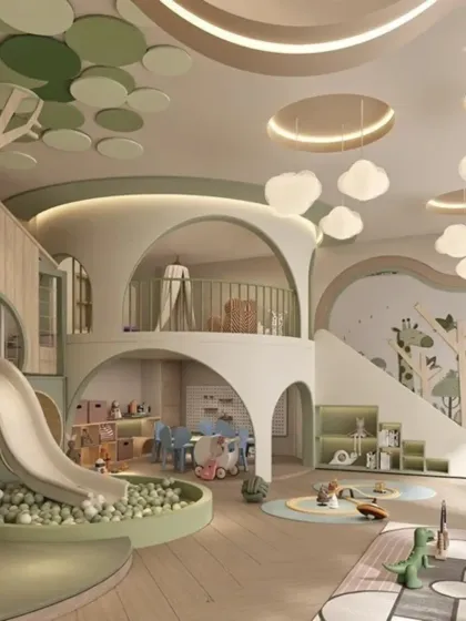 This angle shows the multi-level design of the playzone, with a slide connecting the upper and lower areas. The space includes a small table for arts and crafts and plenty of open floor for play.