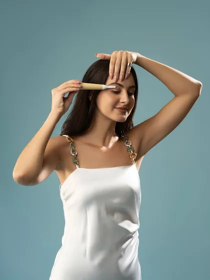 A demonstration of an eyebrow grooming tool. This close-up is perfect for showing the precision and function of the product.
