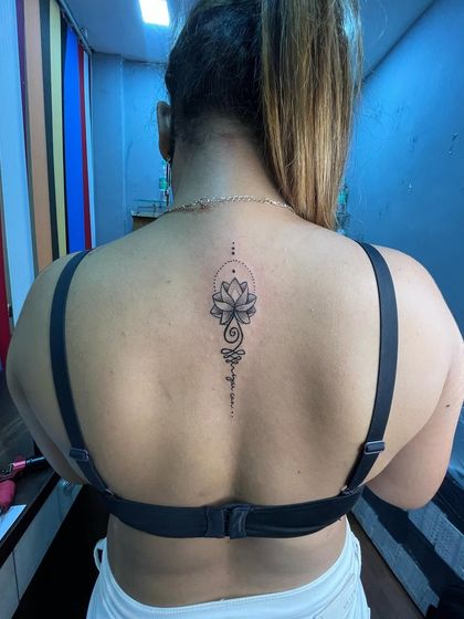 A client showing off her new lotus back tattoo. We ensure every client is happy with the final result.