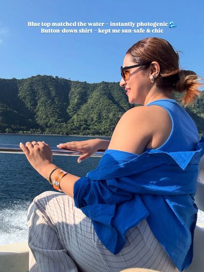 Boat-ready but make it fashion. The blue top matches the water, making it instantly photogenic, while the button-down shirt keeps me sun-safe and chic.