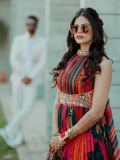 A stylish portrait of the bride, with the groom artfully blurred in the background. We work with photographers to create these creative and beautiful shots.