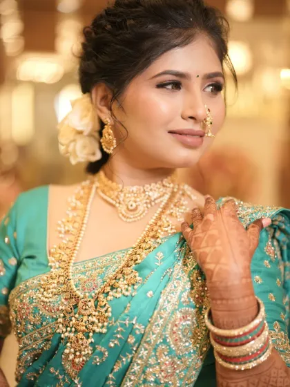 A portrait showcasing the bride's elegant posture and the beautiful details of her saree and jewellery.