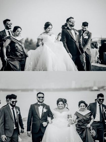 The wedding party walking along the waterfront. This black and white candid shot has a cool, cinematic feel.
