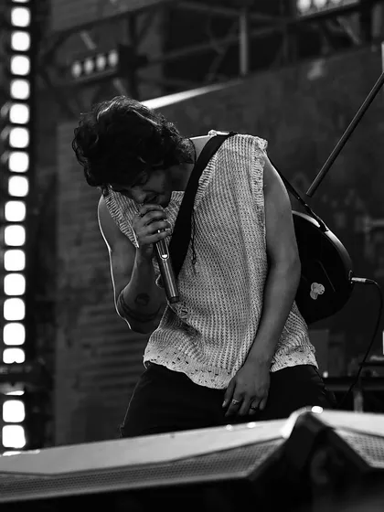 A black and white shot of the lead actor performing on the 'Saiyaara' concert stage, highlighting the emotion of the scene.